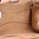 Pebbled leather bag interior with tan lining and stitched side wall