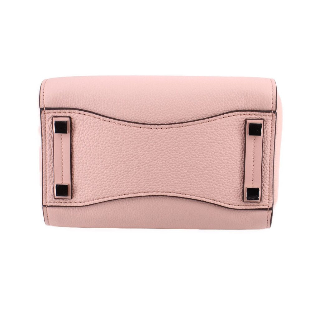 Pink pebbled leather mini bag with top flap and black metal corner details