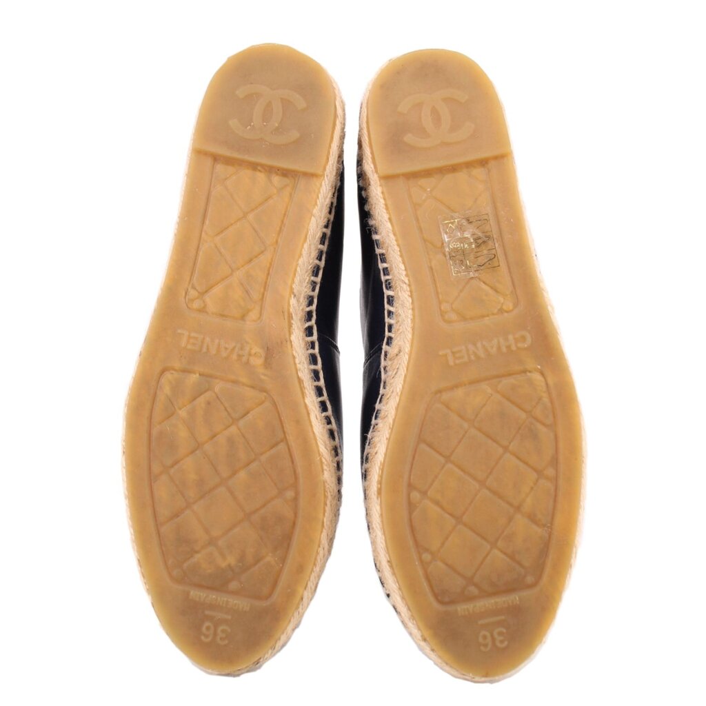 Espadrille flat outsole view with textured tread and embossed branding