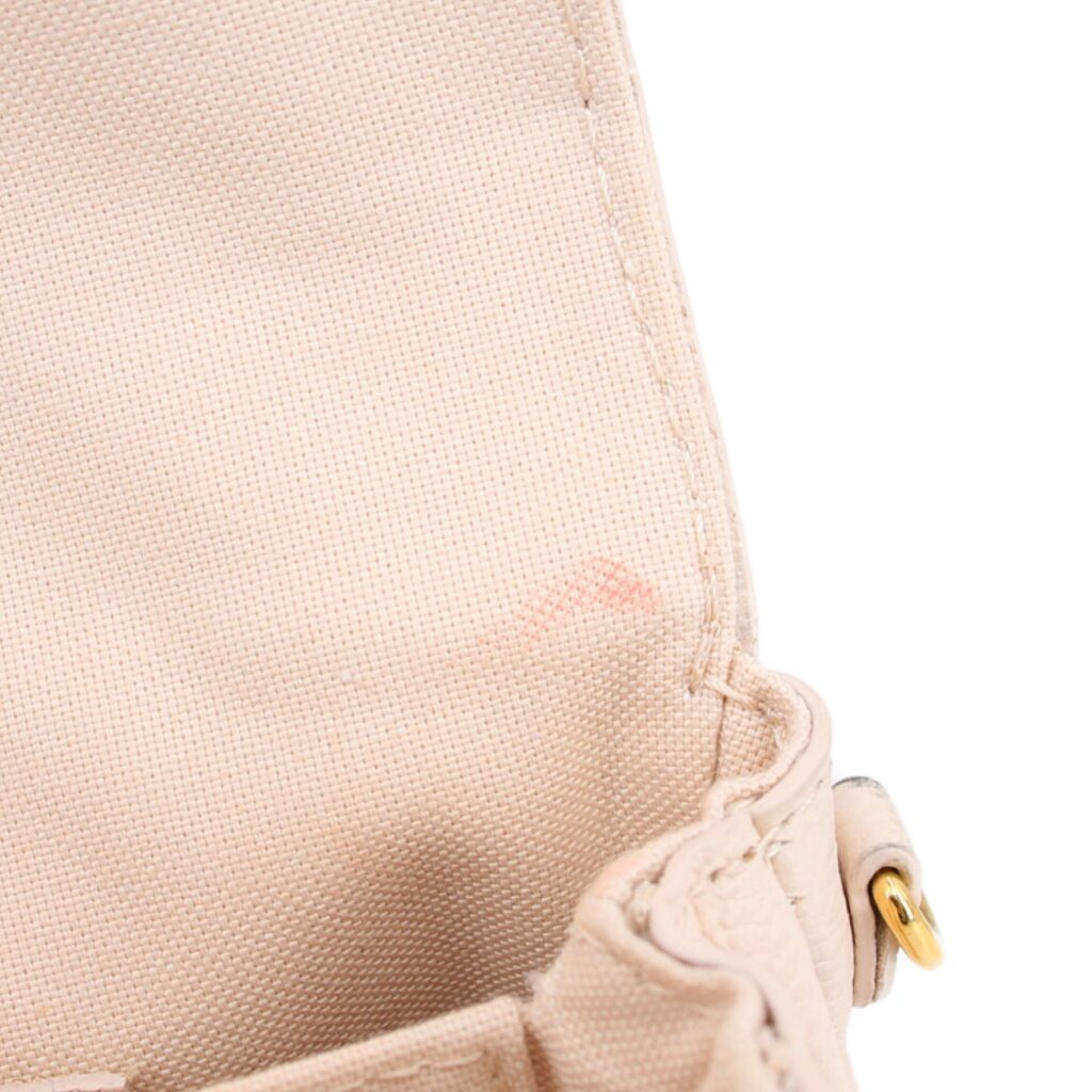Cream Micro Pochette Metis canvas close-up with gold ring and stitching detail