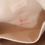 Micro Pochette Metis interior lining: cream fabric with small red speck pattern