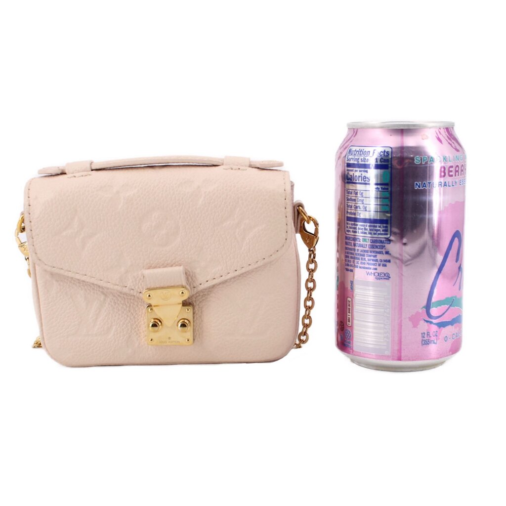 Cream micro crossbody bag side view with gold padlock-style closure
