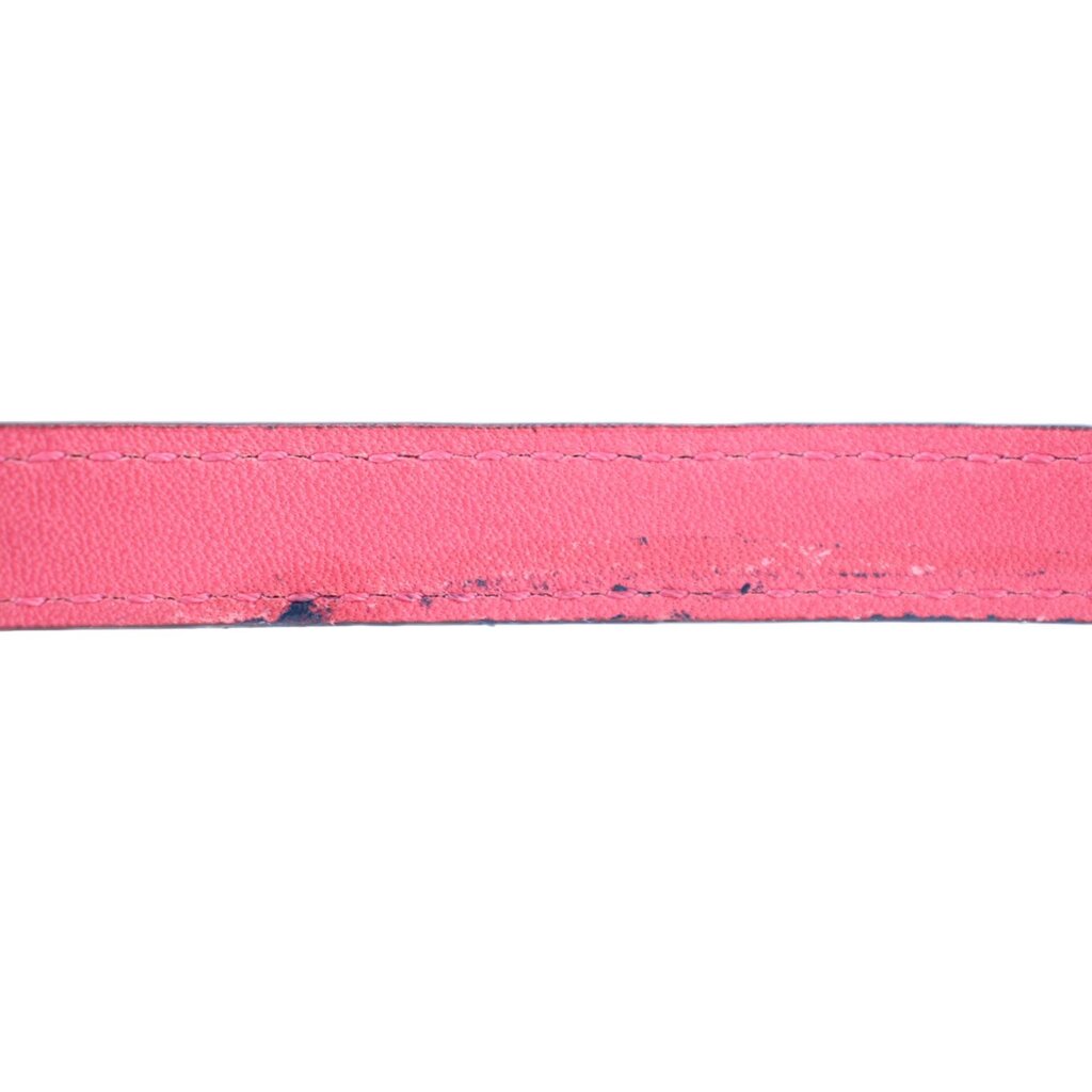 Pink leather edge with visible stitching on the crossbody bag