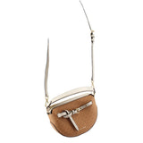 Tan small crossbody bag with long white strap and front buckle strap detail