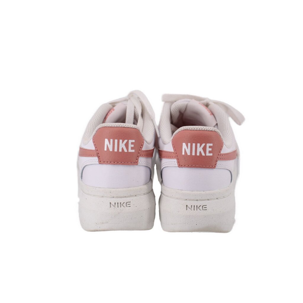 White Nike platform sneakers with pink heel tabs and NIKE branding on back