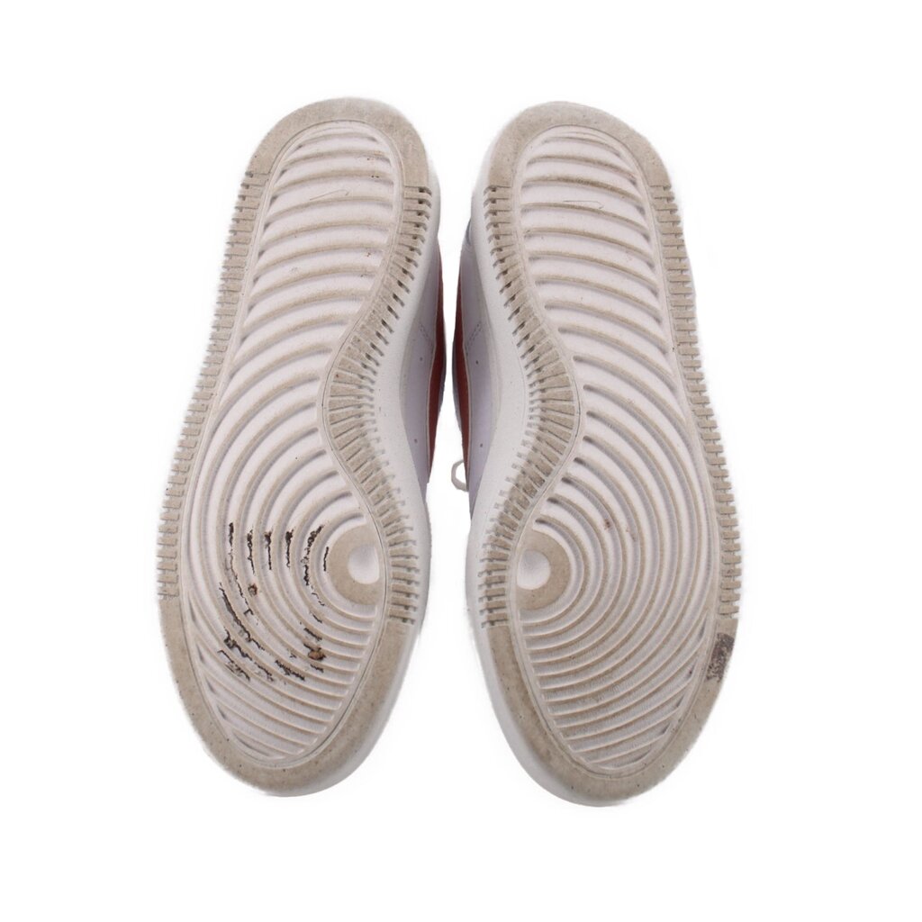 Bottom view of white Nike platform sneaker outsoles with grippy tread pattern