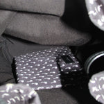 Inside pocket detail of black palm-print backpack lining with label tab
