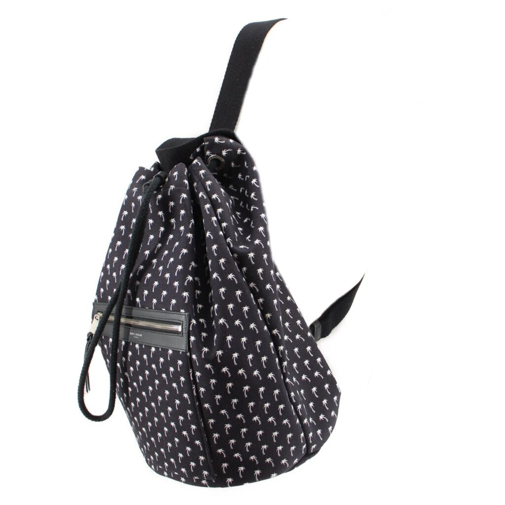Black palm-print backpack, 3/4 view with drawstring cords and front zip pocket