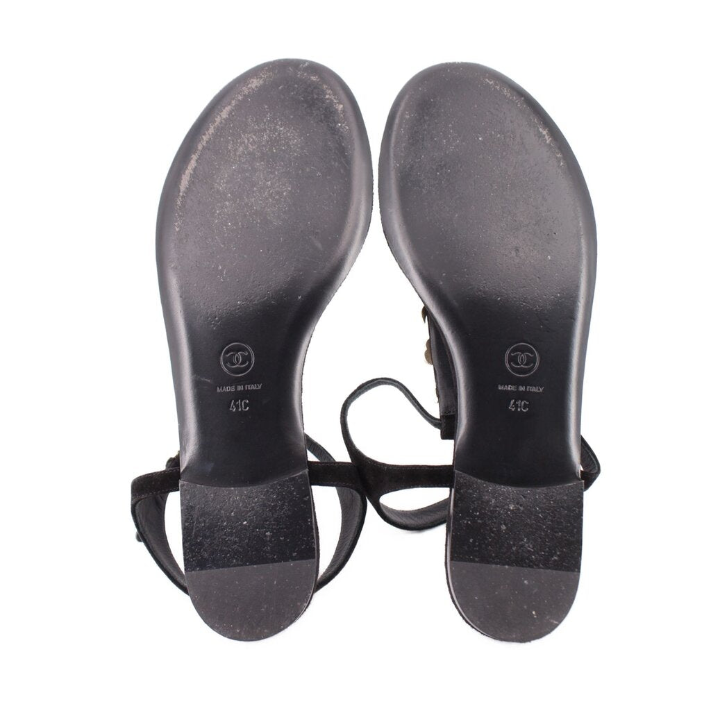 CHANEL black thong sandals outsole view with black straps and gold charms