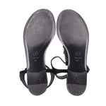 CHANEL black thong sandals outsole view with black straps and gold charms