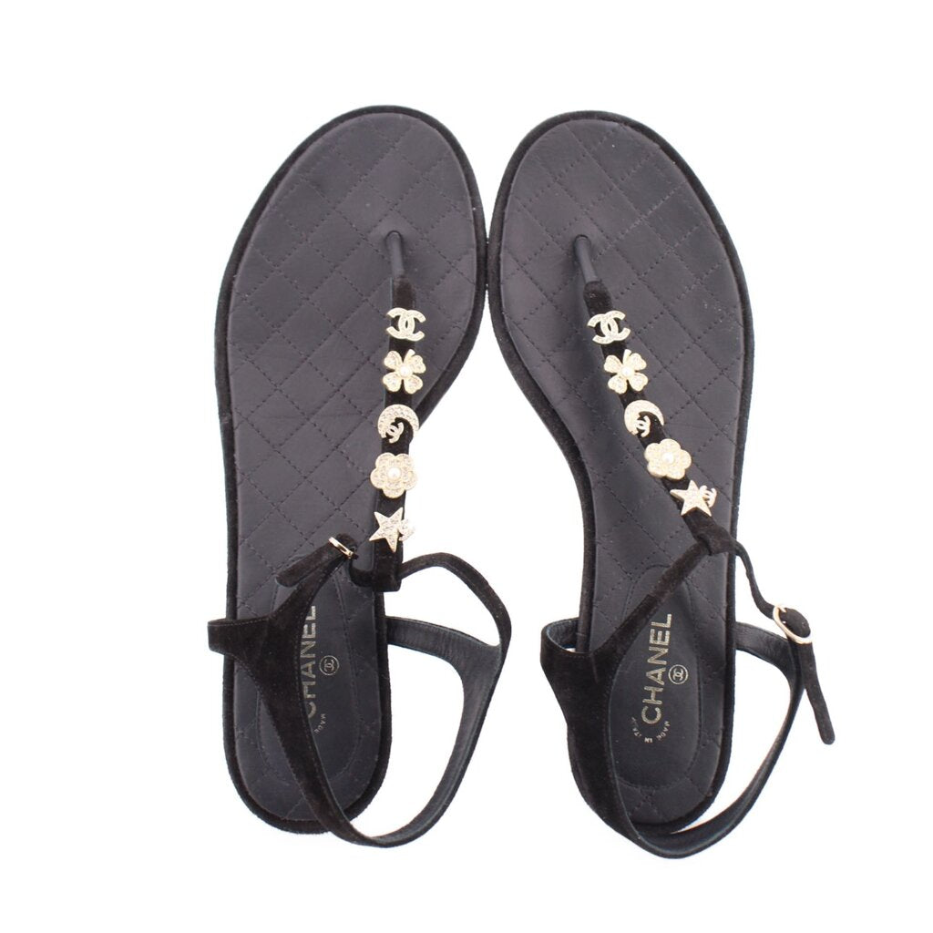Pair of CHANEL black thong sandals with gold flower and star charm strap