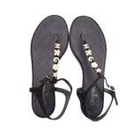 Pair of CHANEL black thong sandals with gold flower and star charm strap