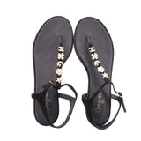Pair of CHANEL black thong sandals with gold flower and star charm strap