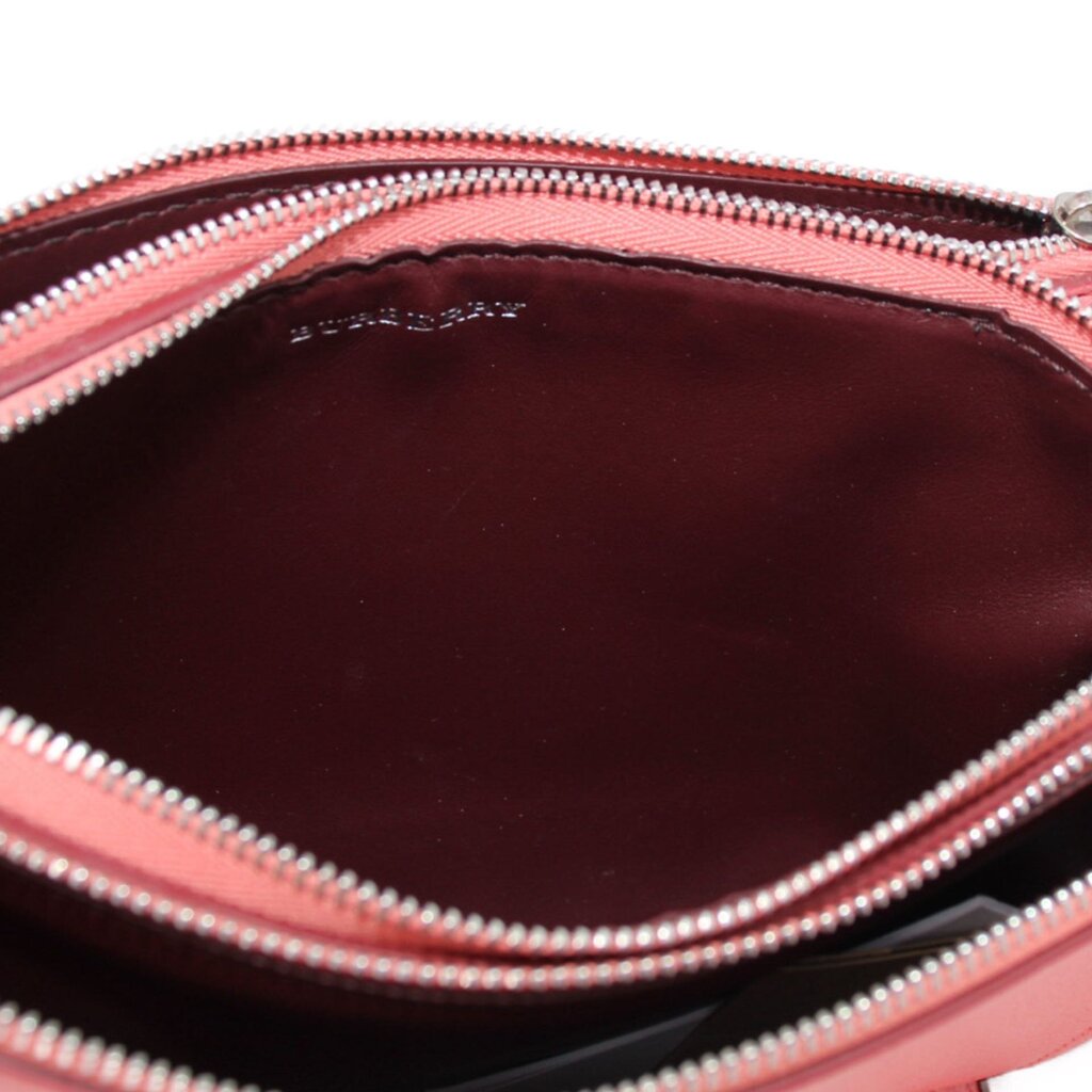 BURBERRY pink crossbody bag interior close-up with zip trim and dark lining