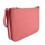 Pink crossbody bag, textured leather, top zip closure and slim shoulder strap