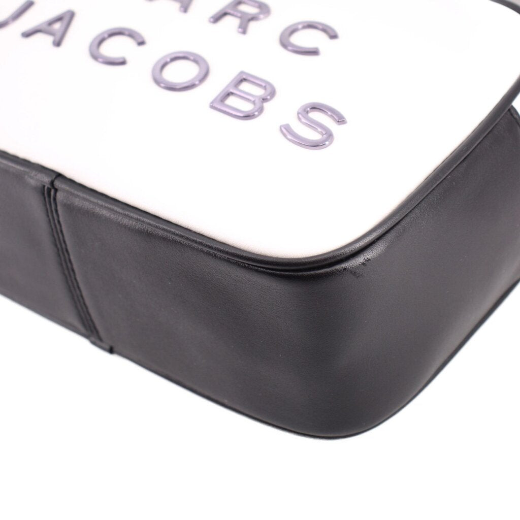 White front corner with black edge seam detail on the two-tone camera bag