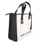 Mini tote bag with black side panel, white front, and top handles