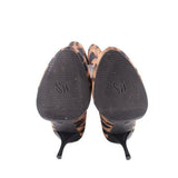 Leopard print booties heels with black rubber soles and branding on outsole.