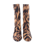 Pair of leopard print ankle booties, pointed toes, stiletto heels, brown.