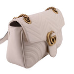 Cream medium shoulder bag side view with chain strap and gold-tone GG clasp