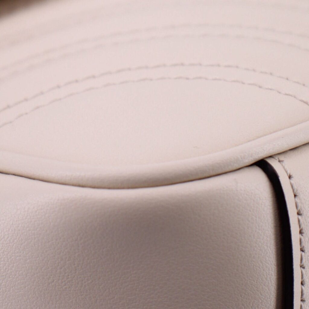 Cream leather trim close-up with edge stitching and smooth panel