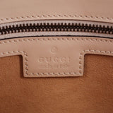 Cream bag zipper close-up with leather label and stitched edge