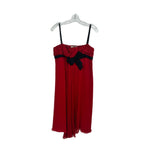 PRADA sleeveless dress in red with black bow and ruffled bodice, pleated hem