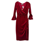Red velvet dress with draped V-neck, long bell sleeves, and side slit