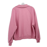 Pink long sleeve top back view with crew collar and raglan seams