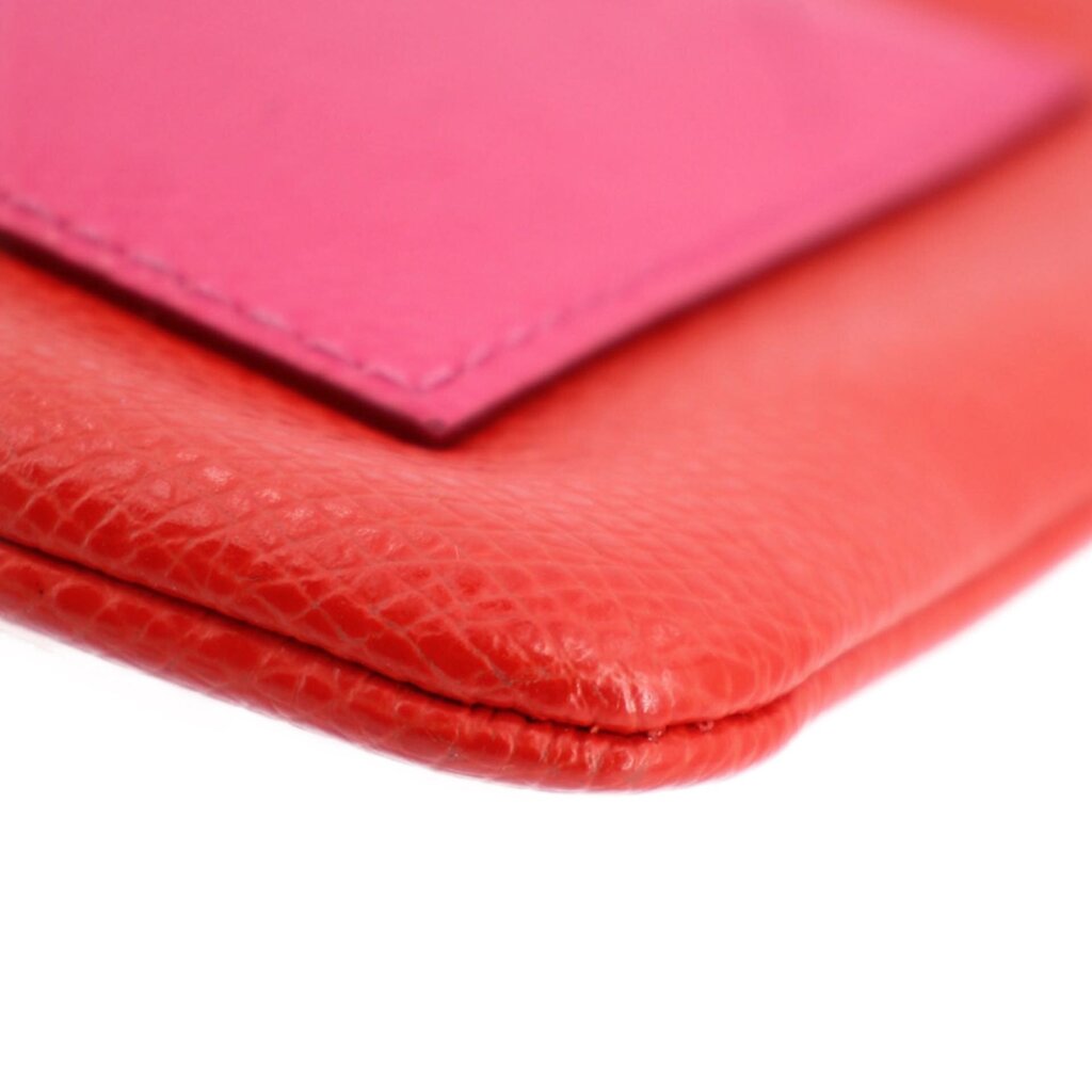 Close-up of wristlet pouch edge stitching and textured leather surface