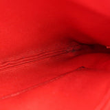 Textured leather close-up on red/pink wristlet pouch interior side panel
