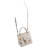 Cream crossbody with top handles and adjustable strap, garden floral embroidery