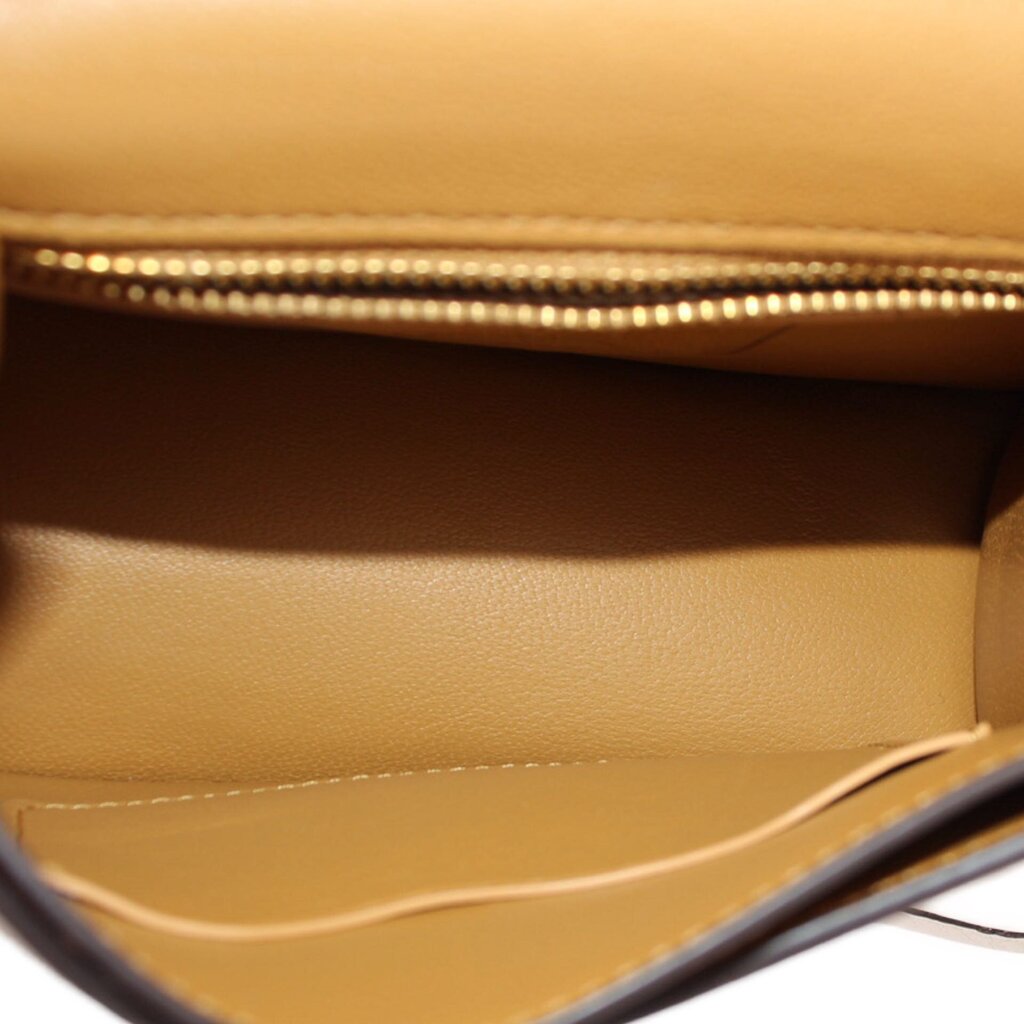Interior of cream bag with suede lining and top zipper edge