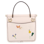 Cream top-handle bag with butterfly charm, garden embroidery, and gold top handles