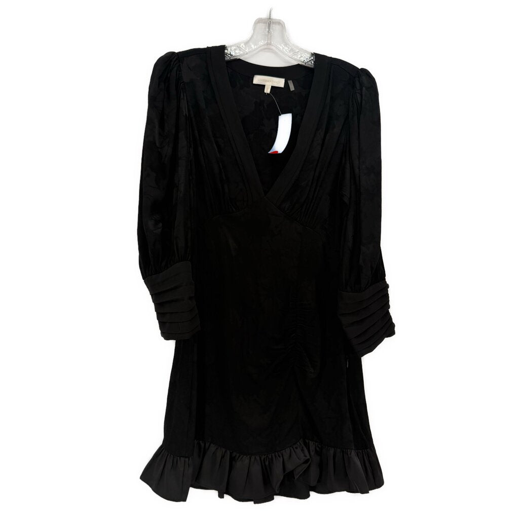 Black long-sleeve dress with V-neck, ruched bodice, puff sleeves, ruffled hem