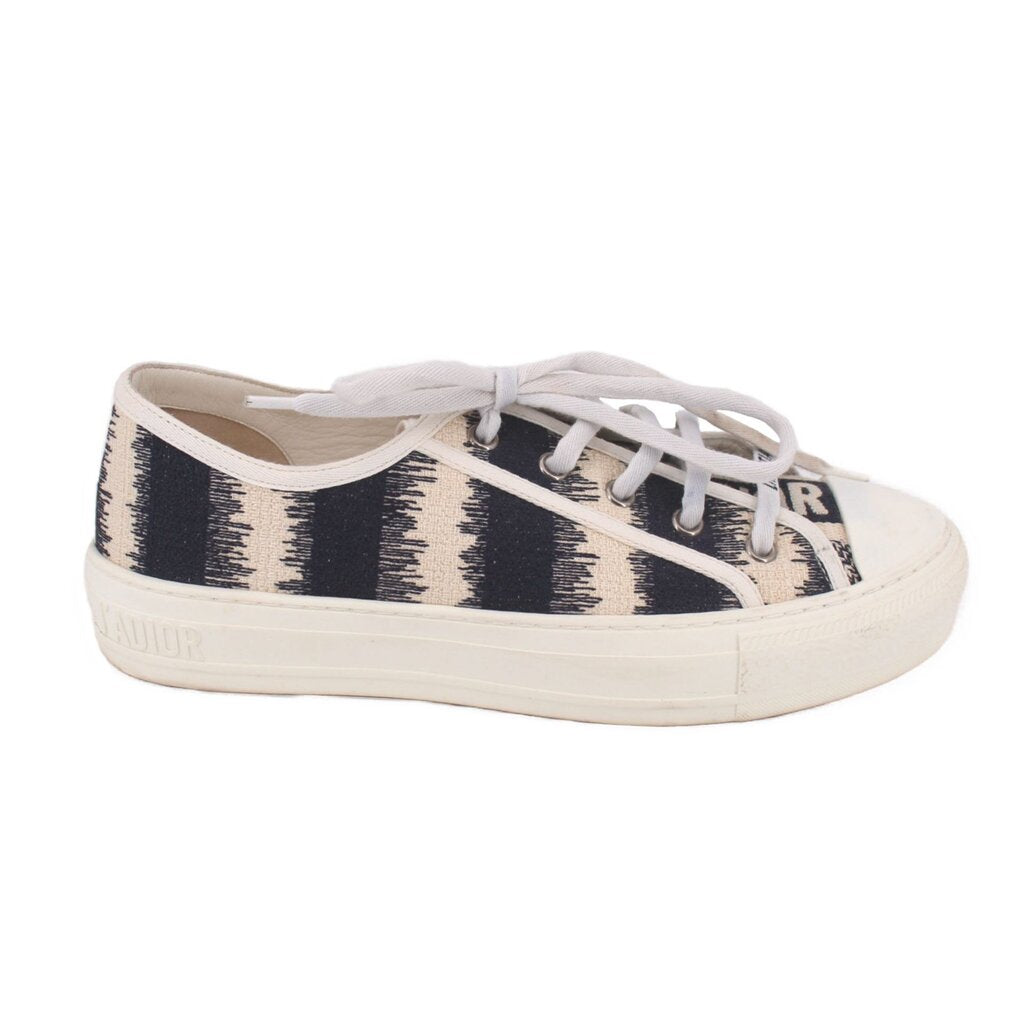 Low-top sneakers with black-and-cream stripe side panels, white laces, DIOR trim