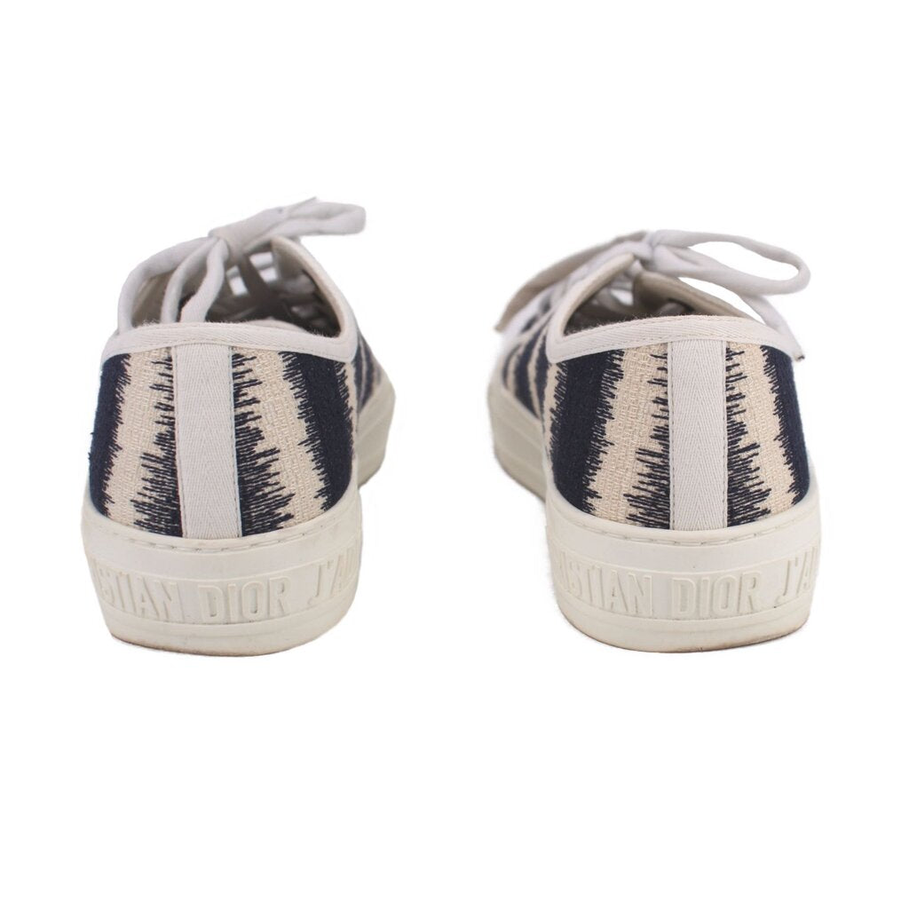 DIOR D-stripe sneakers shown from the back, with heel logo and black-and-cream stripes