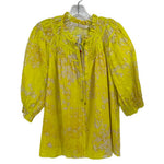 Yellow print blouse with gathered yoke, front button placket, and puff sleeves