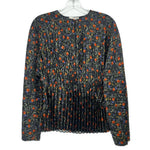 Black pleated long-sleeve top with orange floral print and round neckline