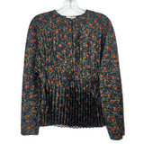 Black pleated long-sleeve top with orange floral print and round neckline