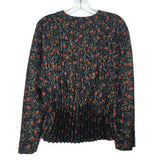 Black floral pleated blouse with long sleeves and crew neckline