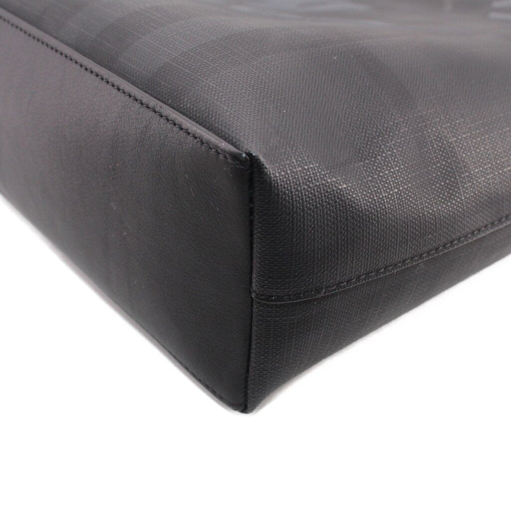 Black tote crossbody bag corner seam detail with curved edge and stitching