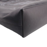 Black tote crossbody bag corner detail with stitched edge and textured surface