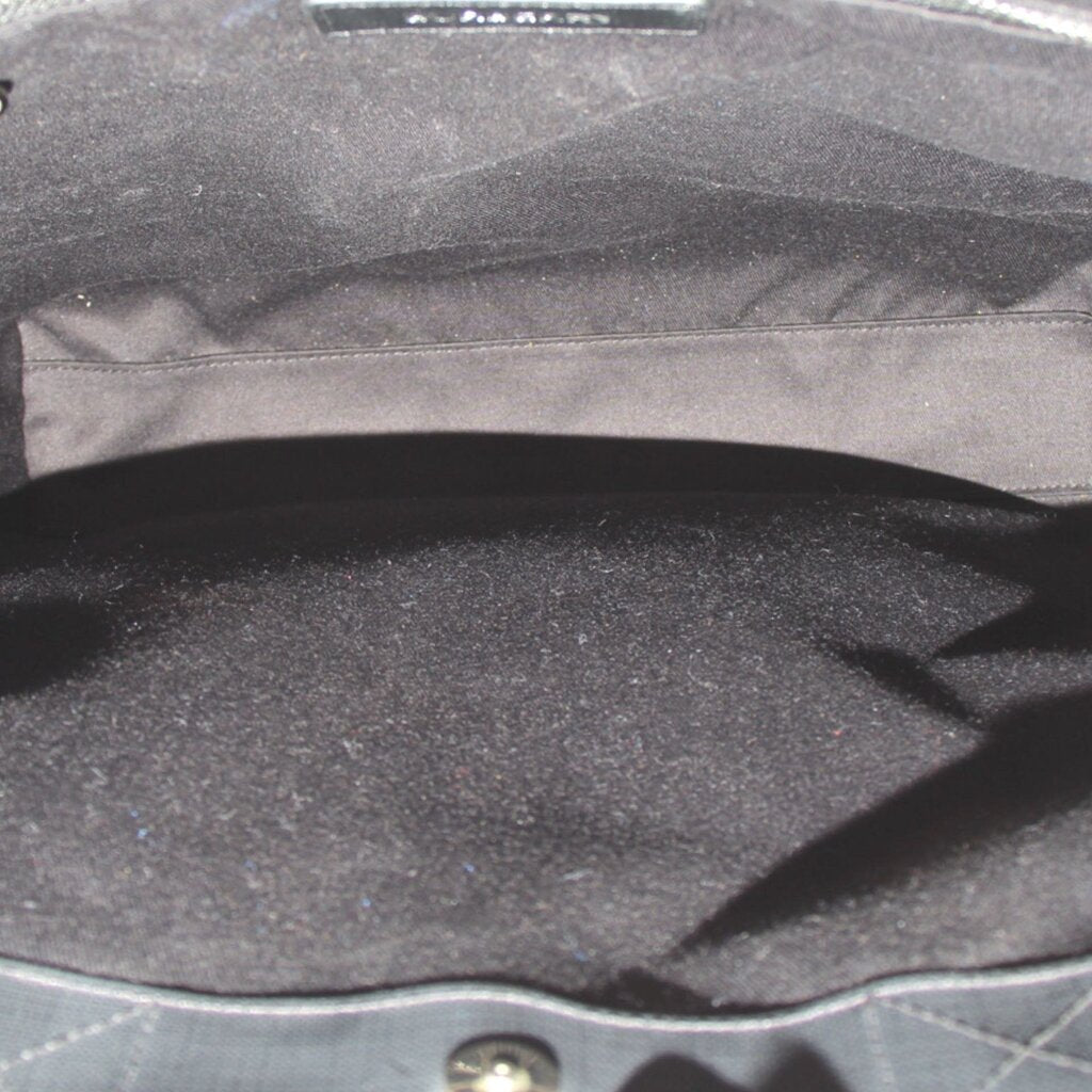 Inside view of black tote with fabric lining and top opening