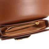 Brown leather shoulder bag interior with zip pocket and gold zipper pull.