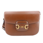 Brown leather shoulder bag with gold Horsebit 1955 clasp.