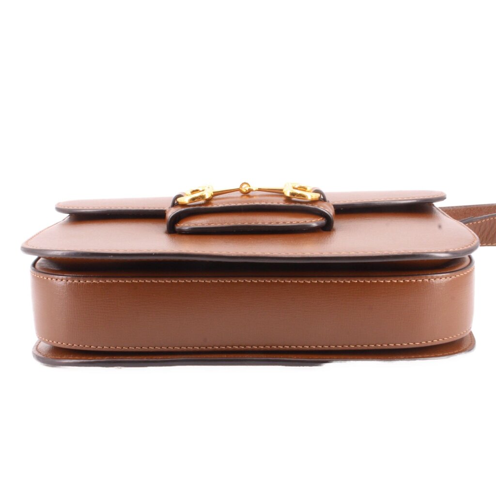Brown leather shoulder bag bottom view with gold Horsebit top hardware.
