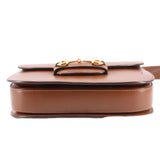 Brown leather shoulder bag bottom view with gold Horsebit top hardware.