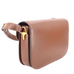 Brown leather shoulder bag side view with Horsebit hardware and strap loop.