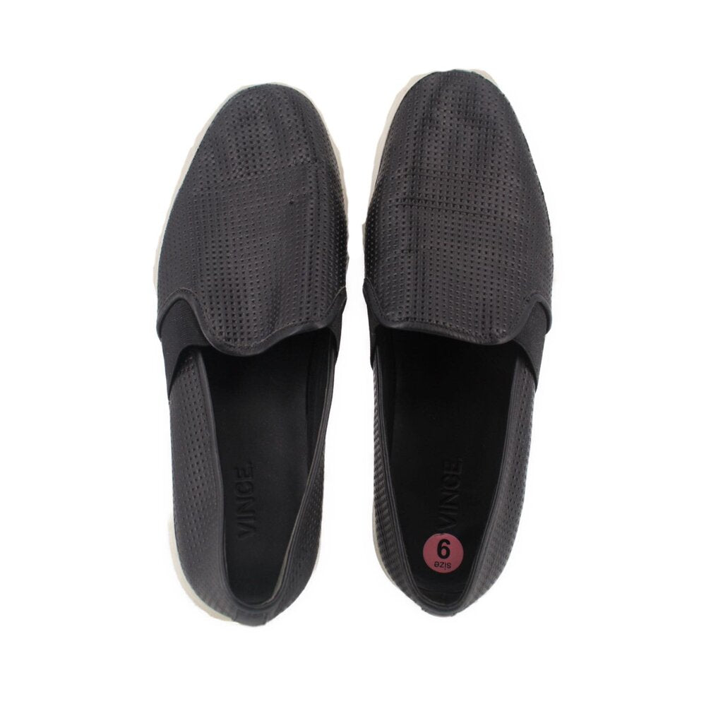 Black perforated flats, showing inside and size label on insole